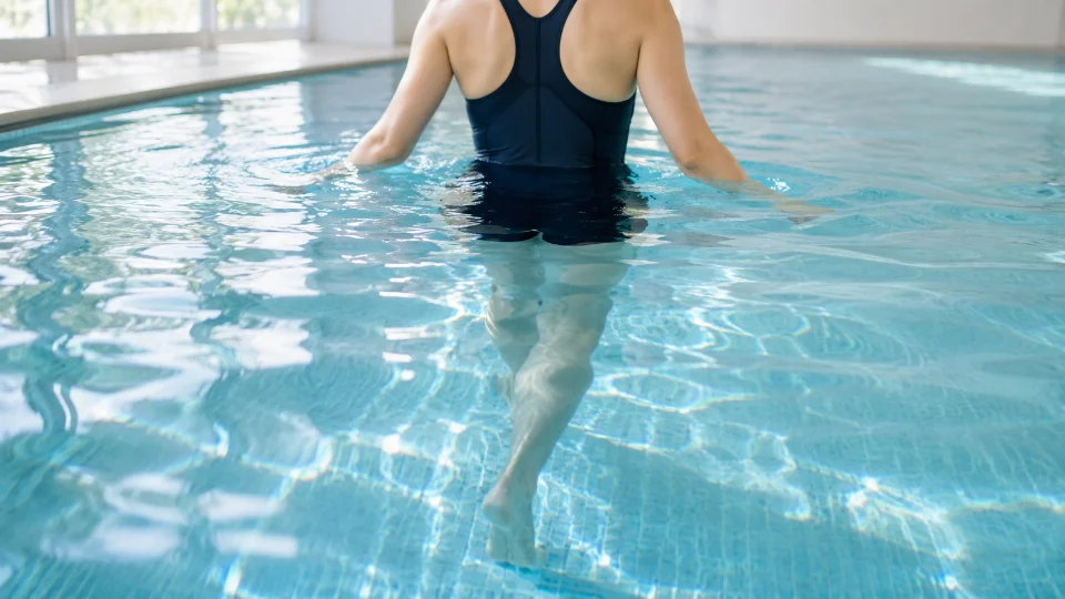 プールの中を歩く(水中歩行する)日本人女性の脚(顔は写していない)